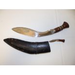 An old kukri with 12" blade in sheath - one small knife missing.