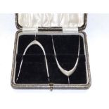 A cased pair of silver wishbone-shaped sugar tongs - Birmingam 1936. (2)