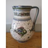 A Cantagalli maiolica jug decorated with fish in green and blue with small flowerheads, blue