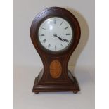 An early 20thC inlaid mahogany waisted balloon shaped mantel clock, the French drum movement