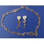An Yves Saint Laurent gilt metal heart chain necklace, 38" and a pair of matching 4" drop