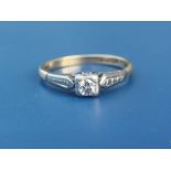 A small diamond solitaire in square setting, '18ct & Plat'. Finger size O/P.