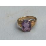 A rectangular cut amethyst solitaire ring on 9ct yellow shank. Finger size L.