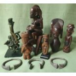 A collection of African carvings, a brass finial, two silver bangles and one other.