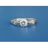 A diamond solitaire ring, the claw set brilliant weighing approximately 0.40 carat, small diamonds