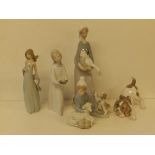 A Lladro porcelain goose girl with puppy 4866, 4.1" high, a crouching puppy A-17F and three other