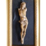 A carved wood crucifix figure, missing arms, possibly 17th/18thC, 10", fixed on later framed mount