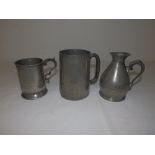 A small 19thC pewter haystack - 'The Main Street…...Son, Cork', 4.8" high and two pewter mugs. (3)