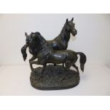 A 20thC French patinated spelter horse group after Bayre/Valton, 19" high.