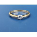 A modern diamond solitaire ring, the claw set brilliant weighing approximately 0.25 carat, on 18ct