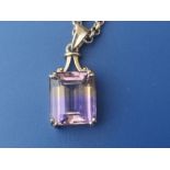 A rectangular ametrine pendant on 9ct necklace chain.