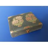 A 1920's silk covered Cartier jewellery case of hinged rectangular form having floral decoration,