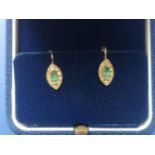A pair of emerald & diamond marquise cluster earrings in 750 yellow metal, the settings 10mm