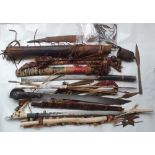 A collection of Eastern weapons including Dyak Mandua and a quiver of arrows.