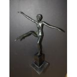 An art deco black patinated spelter dancing girl on square slate pedestal, 12" high.