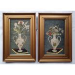 A pair of antique silkwork pictures depicting a vase on a book with flowers, in original glazed