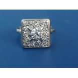 A diamond pave set square panel 18ct white gold ring, the central old cut stone weighing