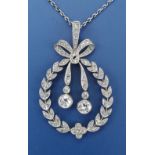 An Edwardian diamond set pendant necklace, the pendant of open oval ribbon-tied garland form, 1.