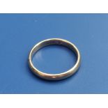 An 18c yellow metal wedding band. Finger size P.