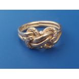 An 18ct gold knot ring. Finger size O.