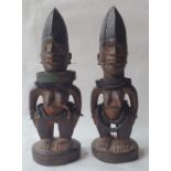 A pair of African Yoruba Ibeji figures, each with metal bead adornment, 9.5" high. (2)