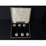 A cased set of six art deco style enamelled silver bean-handled coffee spoons, the bowls decorated