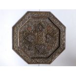 A 19thC Indian brass octagonal tray with copper details, profusely moulded with raised arabesque