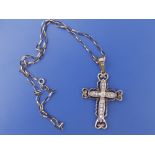A paste set yellow metal cross on necklace chain, the cross 2" excluding loop.