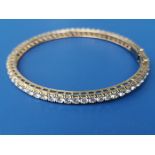 A diamond set bangle, having 63 brilliant cut stones of total weight approximately 7.5 carats -