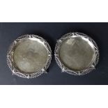 A pair of George III neoclassical style silver waiters by Eames & Barnard, having pierced rims