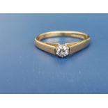 A small modern diamond set 18ct gold solitaire ring. Finger size L/M.