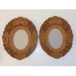 A pair of mid-20thC Chinese carved wood photo frames, decorated figures and grape vine, 10.25". (2)