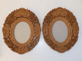 A pair of mid-20thC Chinese carved wood photo frames, decorated figures and grape vine, 10.25". (2)