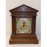 A 19thC German oak striking mantel clock with brass dial & triangular pediment, retailed by Reid &
