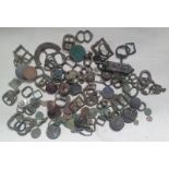 A collection of excavated artefacts including a Saxon and medieval buckles, Roman coins and other