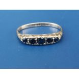 A five stone graduated sapphire 9ct gold ring - shank misshapen.