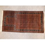 An old prayer rug, the field decorated with detailed geometric pattern in black & brown, cream