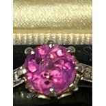 A certified natural pink Sri-Lankan sapphire solitaire ring, the claw set circular cut sapphire