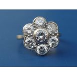 A diamond 'daisy' cluster, the seven collet set brilliants weighing approximately 1.8 carats, on