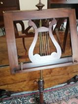 A late Victorian mahogany duet music stand on tripod base.