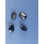 Four unmounted cushion cut sapphires, each measuring approximately 7 x 4.5 x 3mm.