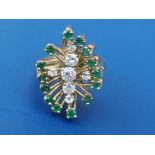 A 1960's emerald & diamond Brutalist style cluster ring, seven claw set brilliant cut diamonds