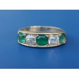 A five stone emerald & old cut diamond ring in yellow metal. Finger size N.