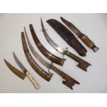 A pair of curved Eastern daggers having inlaid wooden sheaths and hilts, 17" overall together with