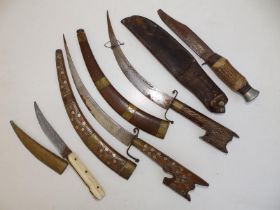 A pair of curved Eastern daggers having inlaid wooden sheaths and hilts, 17" overall together with