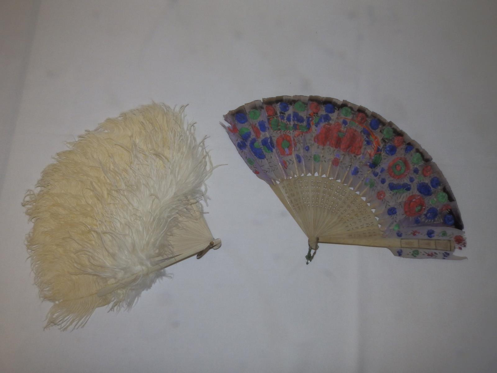 An early 20thC painted feather & bone fan, together with an ostrich feather fan. (2)