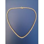 A graduated diamond set line necklace, having 123 claw-set brilliants ranging in diameter from 1.7mm