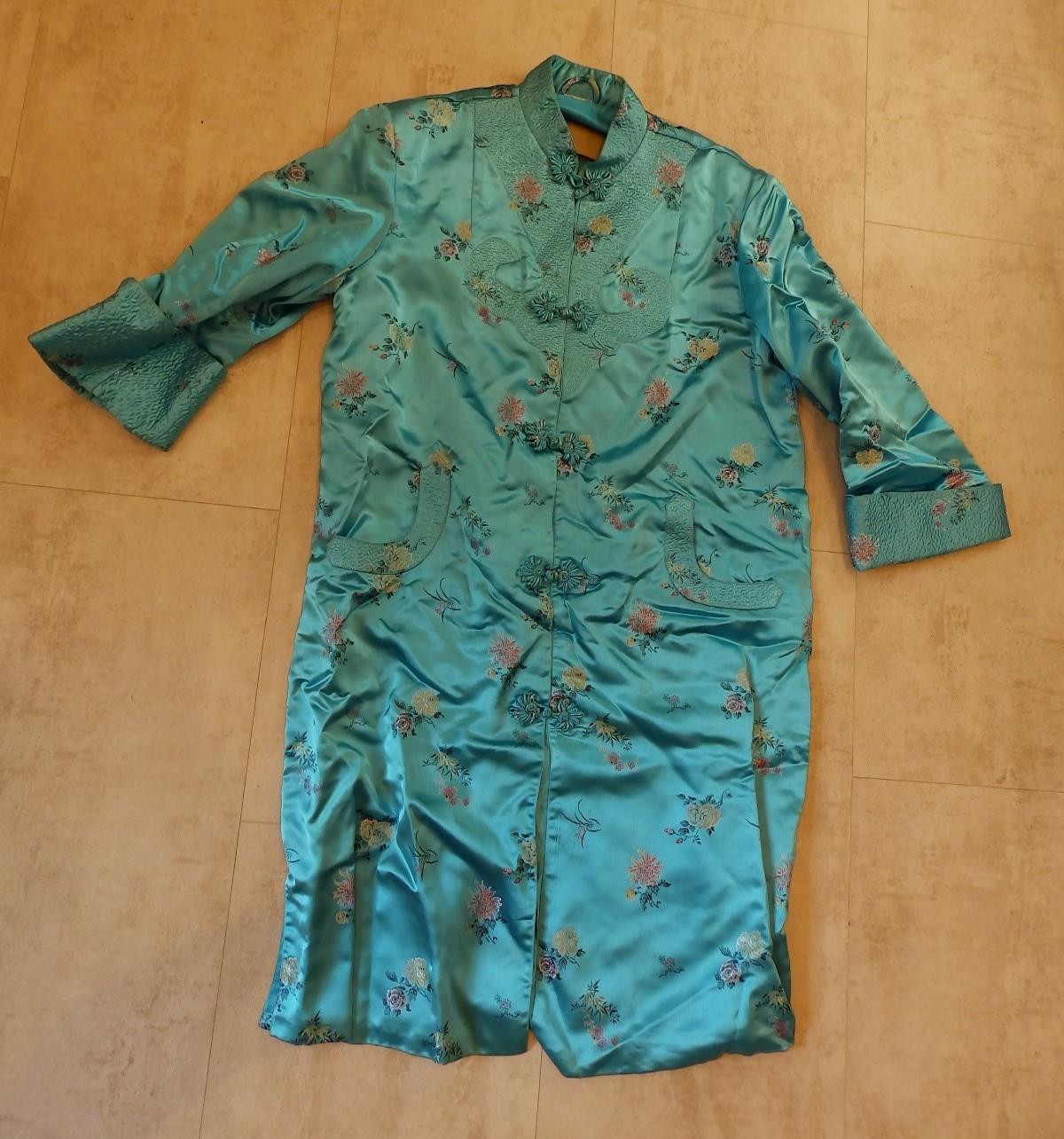 A mid 20thC Chinese silk satin turquoise brocade jacket.