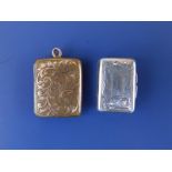 A small Georgian Birmingham silver vinaigrette, 1" and a gold plated rectangular locket. (2)