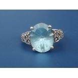 A blue topaz & diamond set 9ct white gold ring. Finger size J.